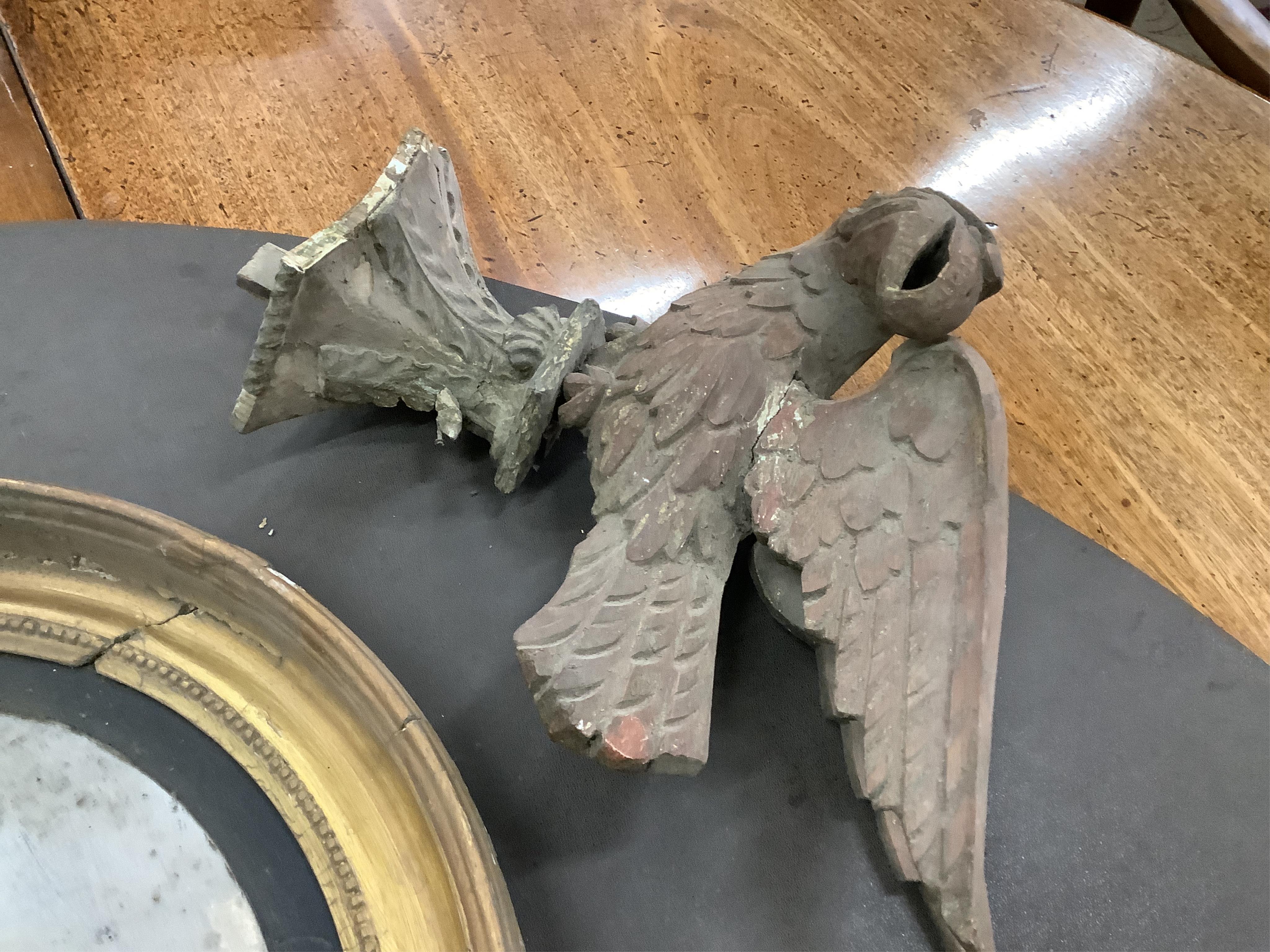 Two Regency circular convex wall mirrors, larger diameter 58cm together with two carved eagle surmounts. Condition - poor